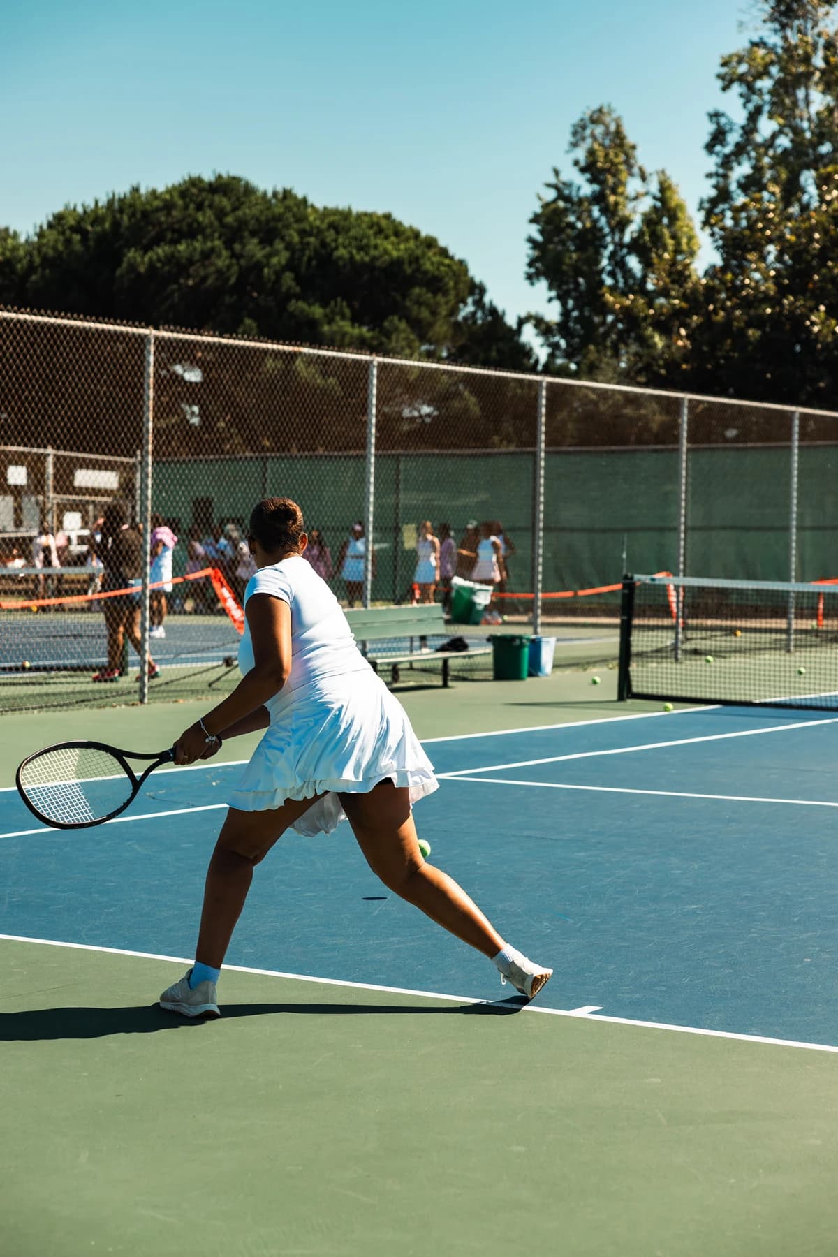 Tennis player serving on an outdoor court