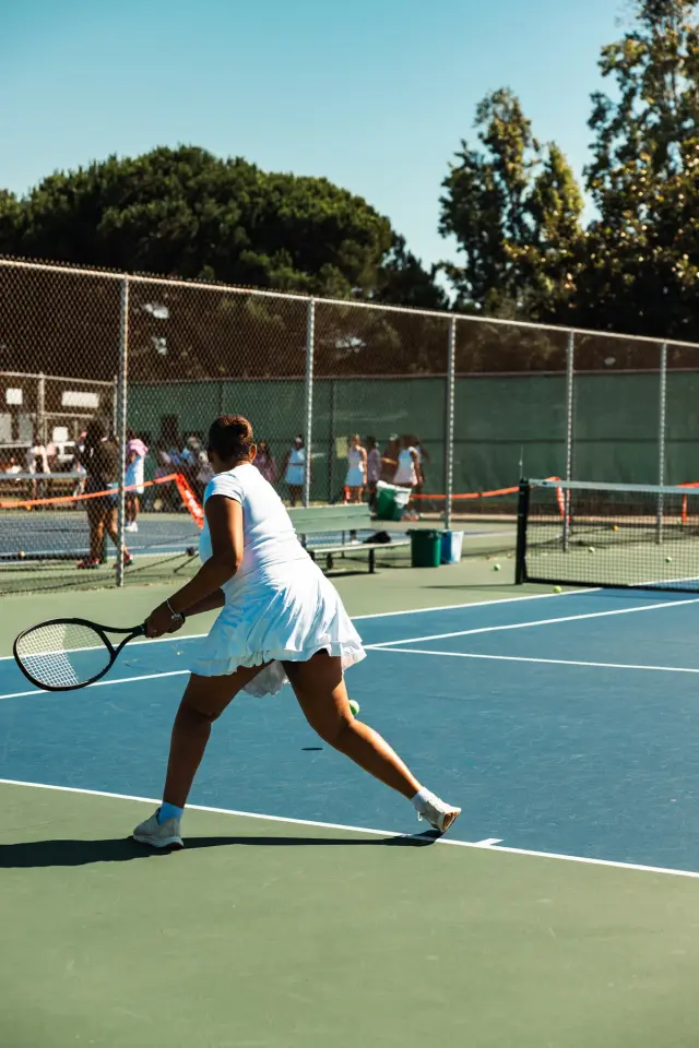Tennis player serving on an outdoor court